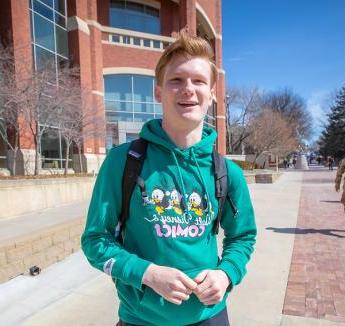 Tyler Langford on sunny day outside Heider College of Business.