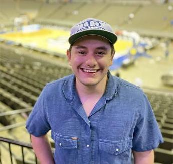 多米尼克的看法 smiling and posing at Creighton basketball pregame.