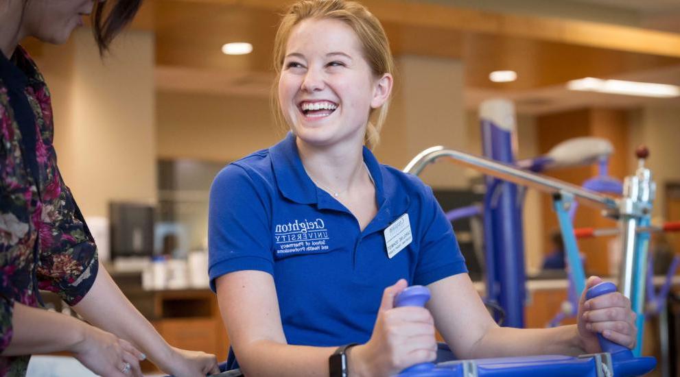 physical therapy student practicing with equipment